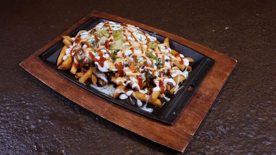 Loaded fries on a sizzling plate