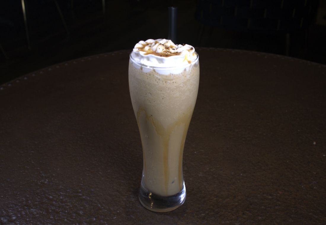 Iced coffee topped with whipped cream and caramel