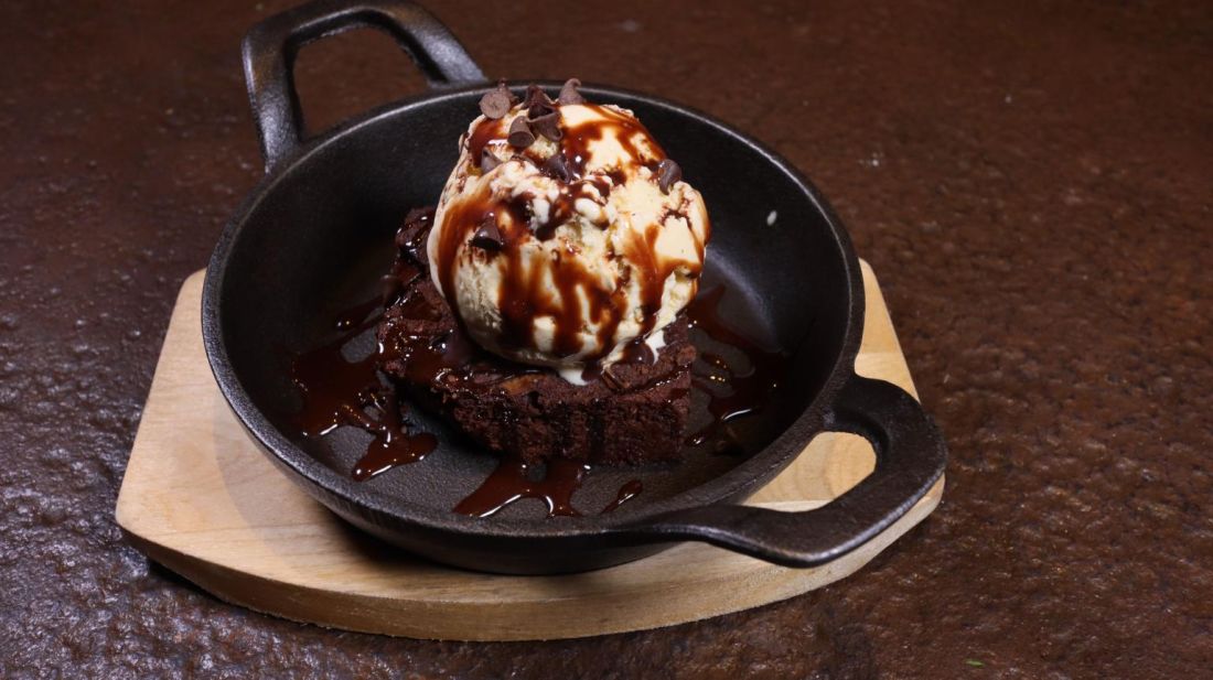 Brownie with ice cream in a cast-iron skillet