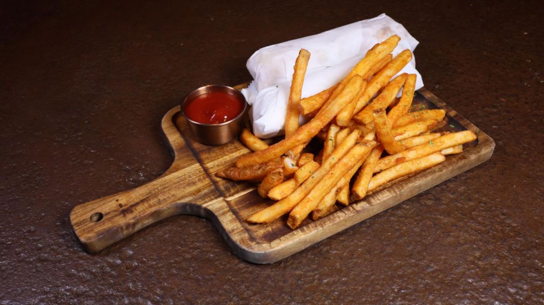 Seasoned fries on a wooden board