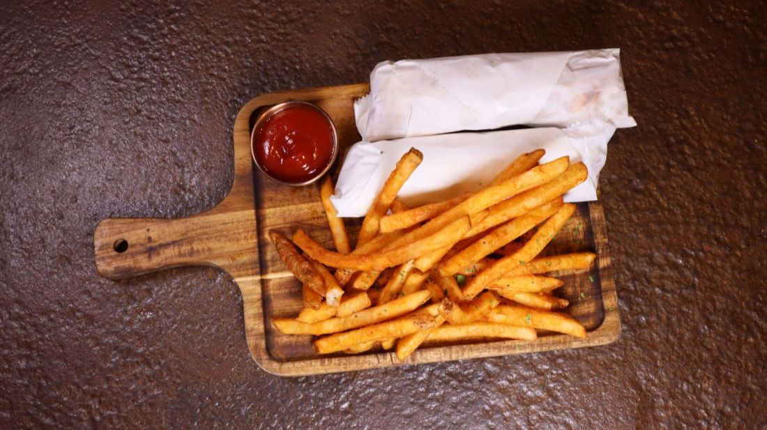 Seasoned fries on a wooden board